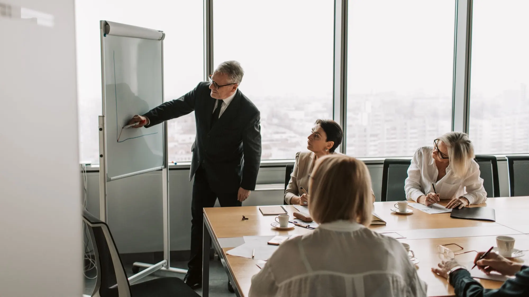 An instructor leading a self storage management training session in a conference room